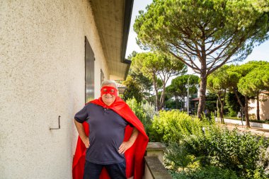 senior posing as superhero with red cloack and mask clipart