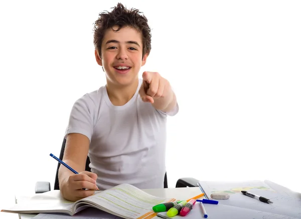 Adolescente chico en la tarea sonriendo y señalando dedo índice — Foto de Stock