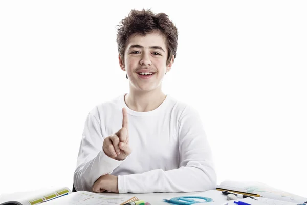 Teenager boy on homeworks smiling and showing number 1 — Stock Photo, Image