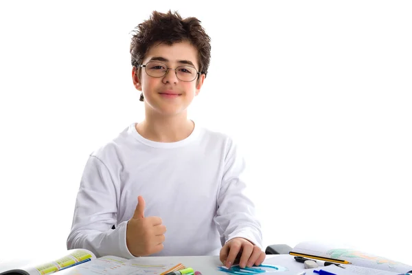 Young boy on homework smiling and showing success sign — Stock Photo, Image