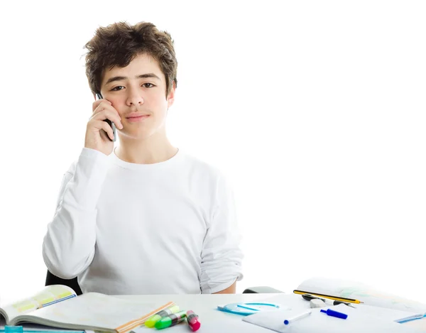 Boy talking on mobile phone on homeworks — Stock Photo, Image