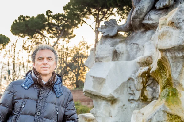 man near an ancient Roman monument