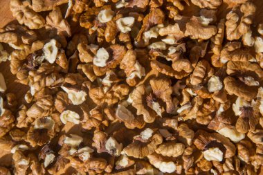 Soyulmuş Ceviz yığınına yakın çekim. Tahta kesme tahtasındaki ceviz arkaplanı. Seçici Odaklanma, farklı dokulara sahip fındıklar