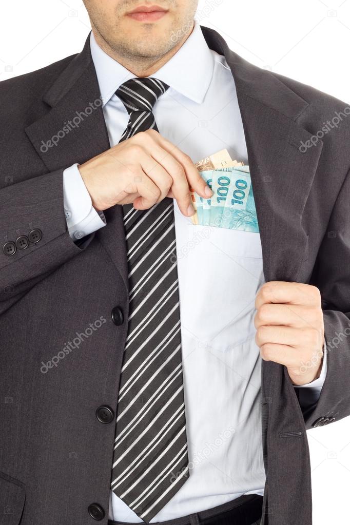 Businessman putting money in pocket