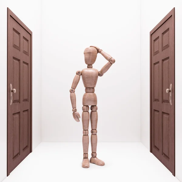 Wooden doll between two doors — Stock Photo, Image