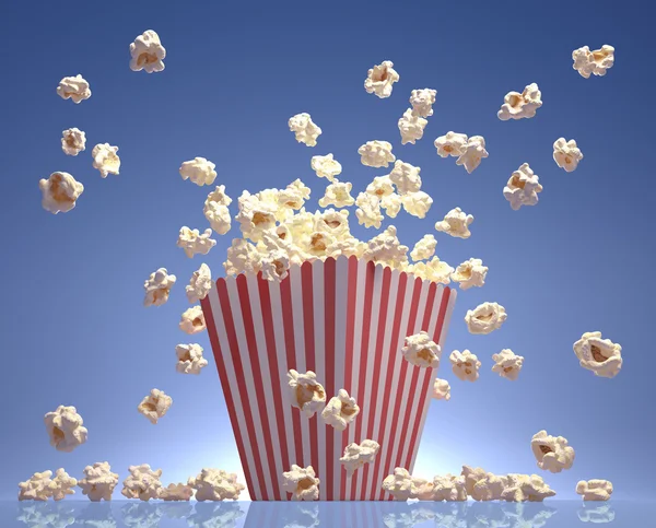 Popcorn exploderen in de verpakking gestreept. Stockfoto