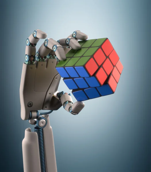 Robotic hand holding a colorful cube — Stock Photo, Image