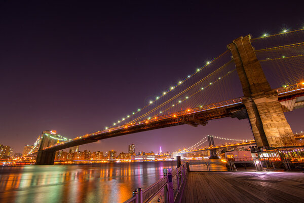 Brooklyn Bridge with Manhattan on a background at night