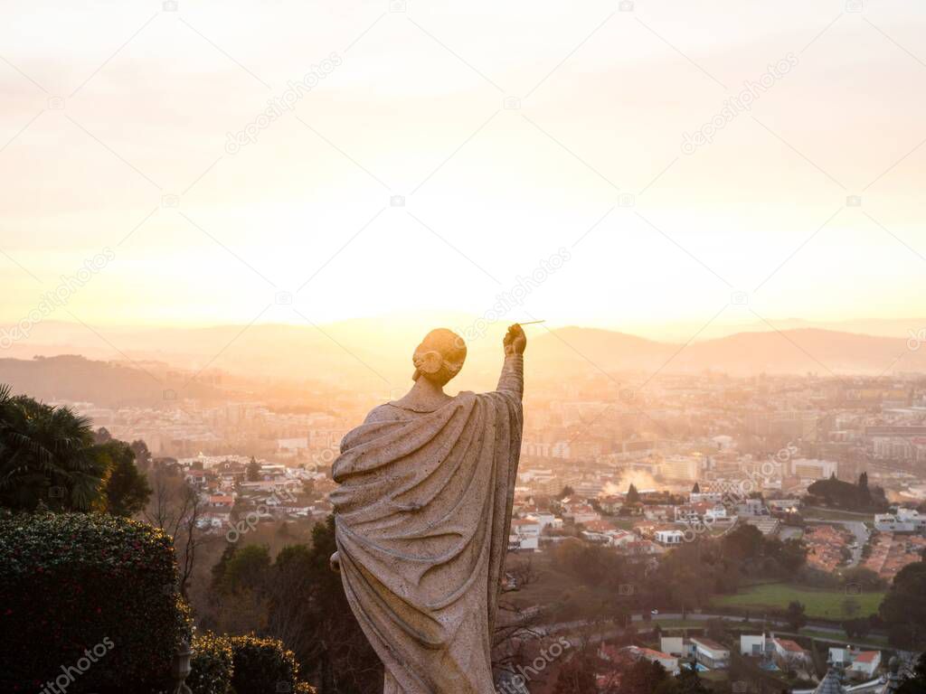 Panorama sunset view of lady figure statue on stairway of Bom Jesus do Monte sanctuary in Tenoes Braga Minho Portugal