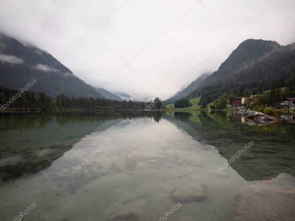 Panorama reflection of alpine mountain lake Hintersee cloudy mystical mood Ramsau Berchtesgadener Land Bavaria Germany