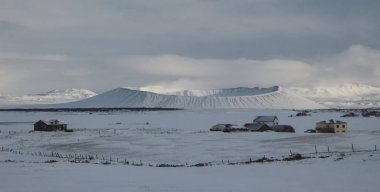 Panorama snowy winter landscape view of huge volcano cone crater Hverfjall near Myvatn Reykjahlid Northern Iceland clipart