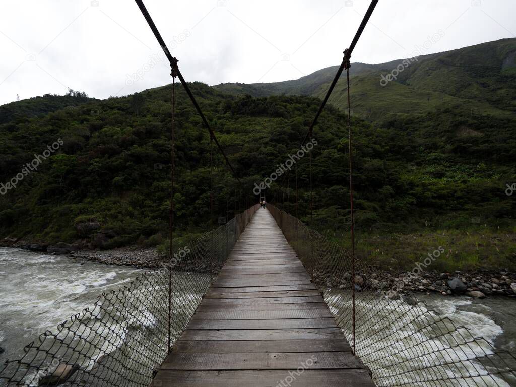 Wooden cable suspension bridge over Urubamba river Inca Jungle Trail Santa Teresa Maria Machu Picchu Peru