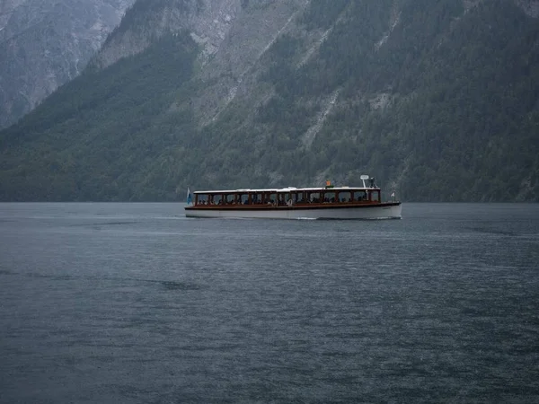 Panorama electric boat on alpine mountain lake Konigssee Koenigssee King Schonau Berchtesgaden Bavaria Germany alps