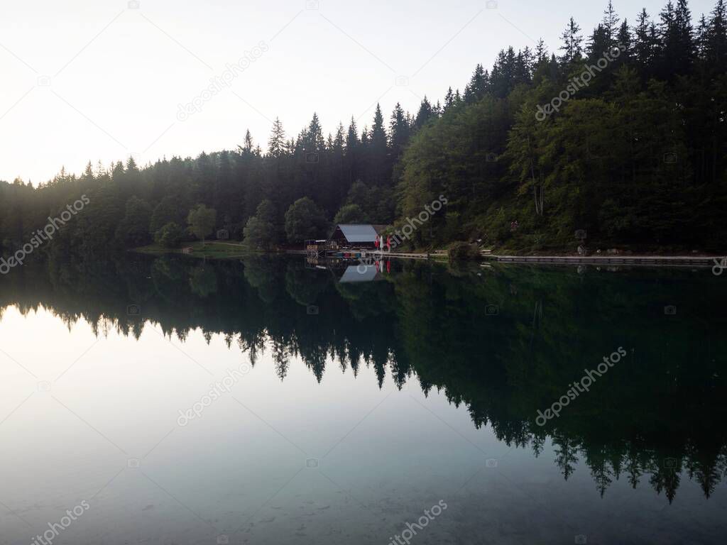 Alpine mountain lake boathouse panorama at Laghi di Fusine Weissenfelser See in Tarvisio Udine Dolomites alps Italy