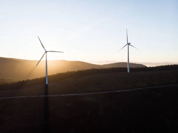 Sunrise panorama of wind turbines farm park on mountain hill top at Baloico do Trevim Lousa swing Coimbra Portugal