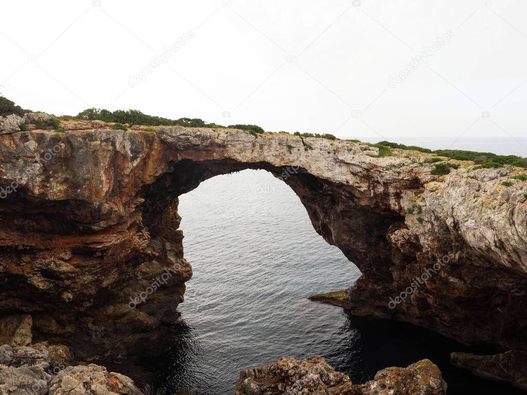 Panorama view of natural arch rock bridge at Cala Varques Calo Blanc Mallorca Majorca Balearic Mediterranean Spain