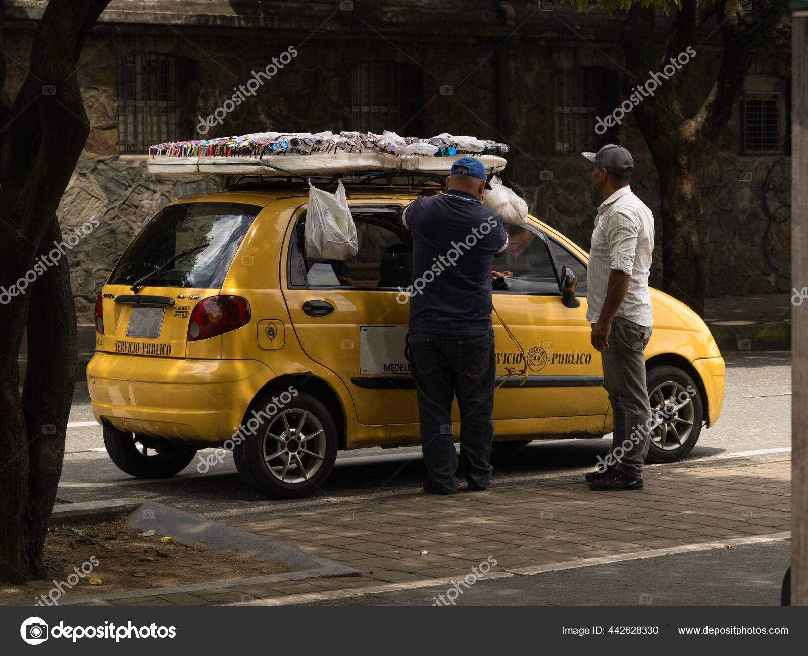 Taxi Driver Arranging Sunglasses Shades Display Board On Car Cab.