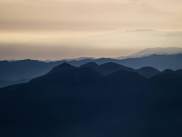 Panorama view of mountain range silhouette layers haze dust fog clouds at Misti volcano Arequipa Peru Andes
