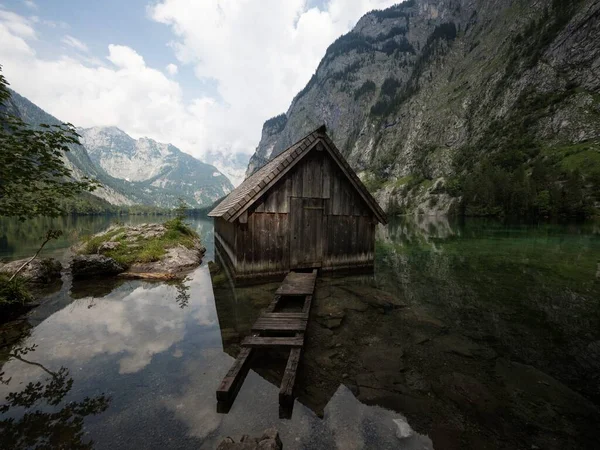 Panorama reflection of wooden boat house shed alpine mountain lake Obersee Fischunkelalm Berchtesgaden Bavaria Germany — Stock Photo, Image