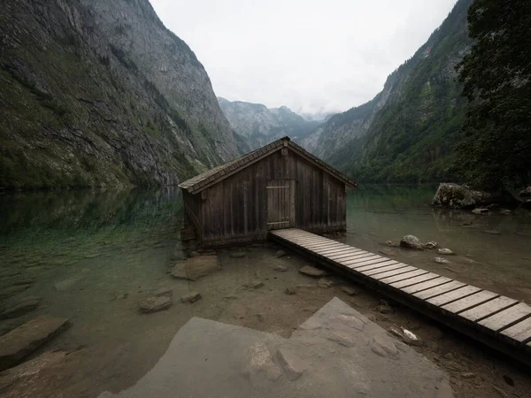 Panorama reflection of old wooden boat house shed alpine mountain lake Obersee Koenigssee Berchtesgaden Bavaria Germany — Stock Photo, Image