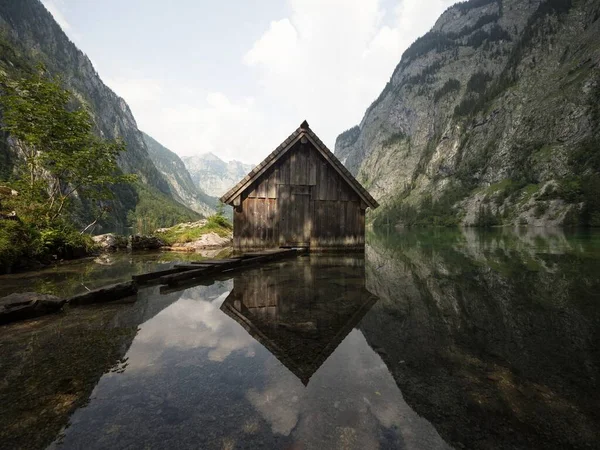 Panorama reflection of wooden boat house shed alpine mountain lake Obersee Fischunkelalm Berchtesgaden Bavaria Germany — Stock Photo, Image