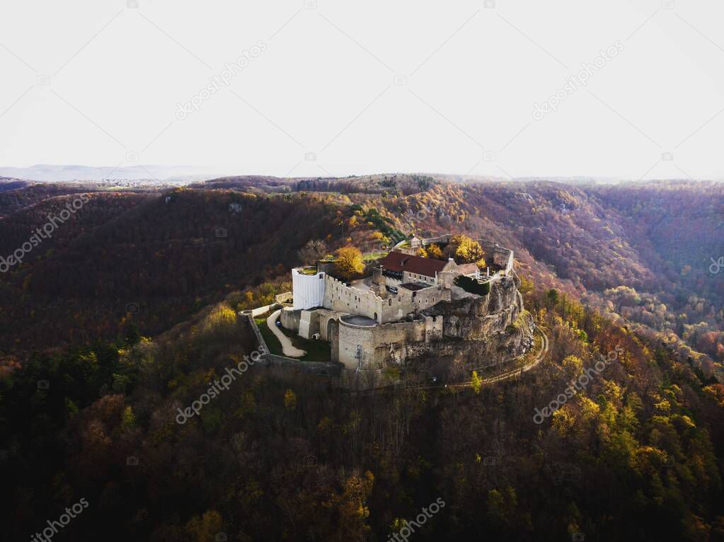 Panorama view of Burgruine Hohenneuffen castle ruins on top of hill near Neuffen BaWu Germany in autumn fall foliage