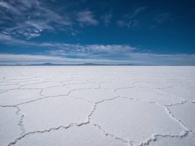 Endless boundless infinite vastness width expanse dreamy landscape of hexagonal shape white salt flat lake Salar de Uyuni in Potosi Bolivia South America clipart