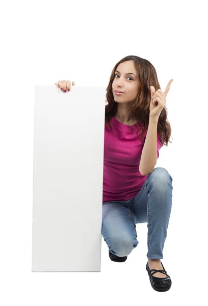 Young woman with an advertisement billboard pointing up — Stock Photo, Image