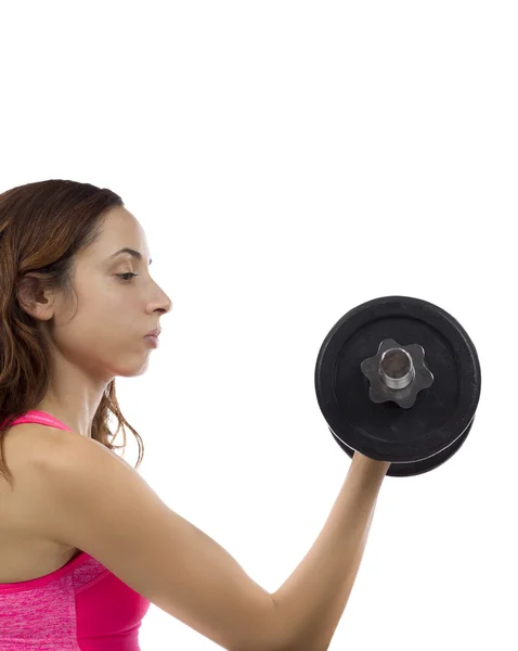 Concentrated fitness woman working out her biceps — Stock Photo, Image