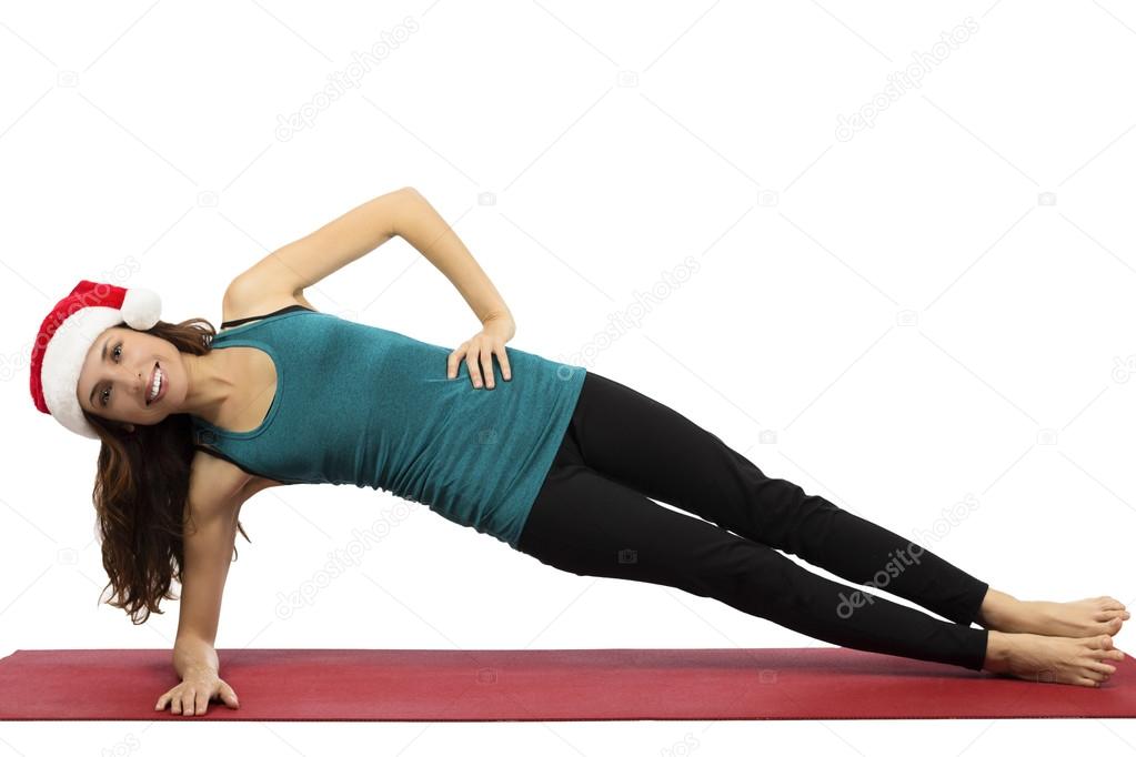 Christmas yoga woman in side plank pose