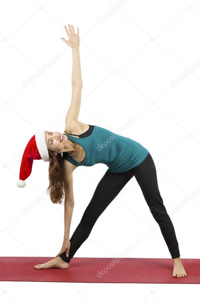 Christmas yoga woman doing extended triangle pose