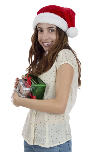 Woman with Santa Claus hat holding onto her gifts — Stock Photo, Image