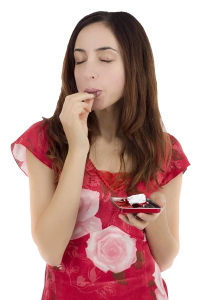 Woman enjoying heart shaped chocolate — Stock Photo, Image