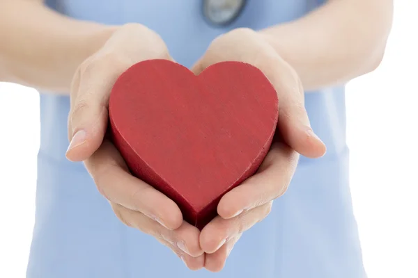 Doctor or nurse holding heart — Stock Photo, Image
