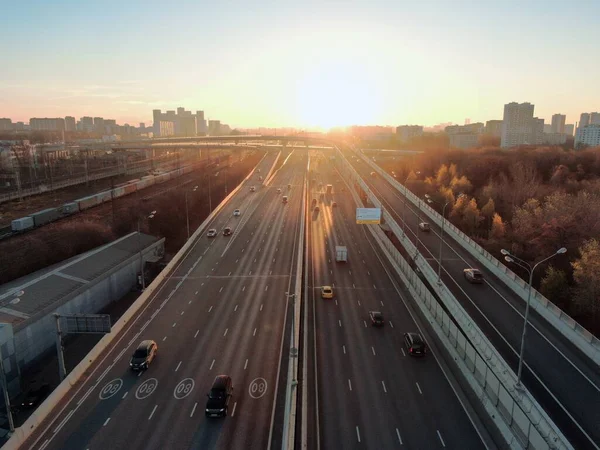 Aerial view panorama of multi-level transport interchange in the center of the big city at sunrise. Beautiful panoramic landscape infrastructure of modern city from great height