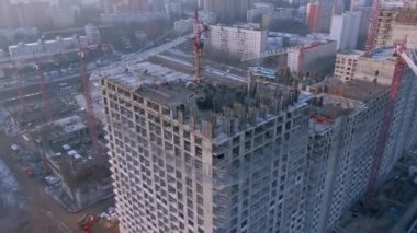 Modern bir ofis binasının havadan görünüşü. Kule vinçlerinin, şehrin arka planına karşı çalışması