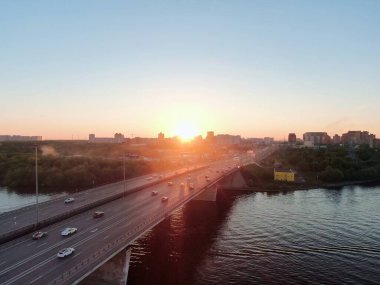 Hava manzarası gün batımında Moskova 'da köprüde güzel bir araba trafiği manzarasıdır. Gün batımında renkli şehir manzarası
