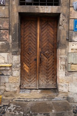 25.02. 2021 City of Lviv, Ukraine, Rynok Square. Original authentic doors on the outskirts of Rynok Square in Lviv. Authentic architecture of the city of Lviv. Doors of the city of Lviv. 