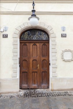 25.02. 2021 City of Lviv, Ukraine, Rynok Square. Original authentic doors on the outskirts of Rynok Square in Lviv. Authentic architecture of the city of Lviv. Doors of the city of Lviv.