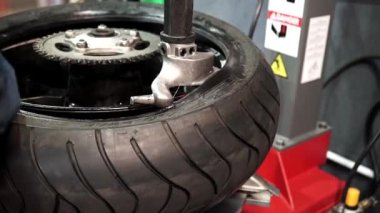 Lastik tesisatçısı lastiği araba diskine takıyor. Lastik tamircisi lastik tamir ediyor. Lastik servisi. Araba servisi. Araba tamirhanesi. Yakın plan.