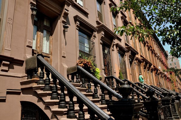 New York City - August 24, 2009: Early 20th century brownstones with high stoops on Manhattan Avenue at West 121st Street in Harlem