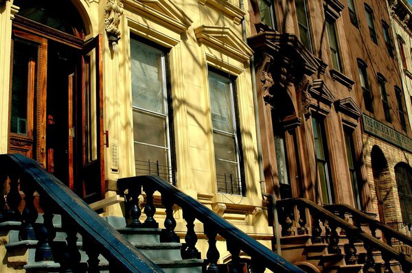 New York City - April 6, 2005: Brownstones with classic stoops and balustrades on West 130th Street in Harlem