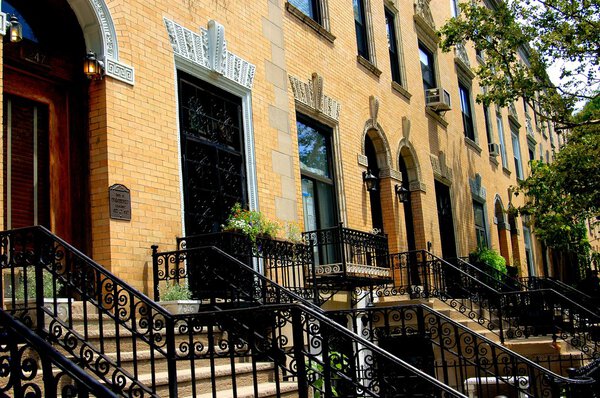 New York City - July 23, 2004: Handsome restored yellow brick townhouses on Striver's Row (West 138th Street) in Harlem