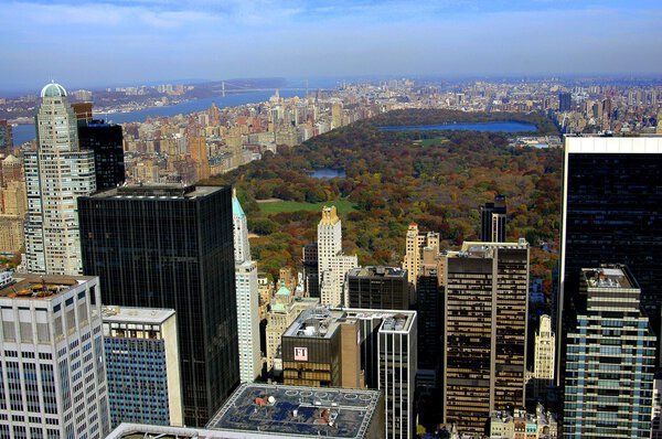 NYC: Vista of Central Park, midtown Manhattan in the foreground, and the Upper West Side, Hudson River, and distant George Washington Bridge on the left