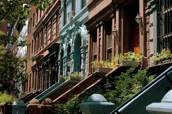 NYC: A row of olassic late 19th century brownstones with staircase stoops on West 78h Street on the Upper West Side