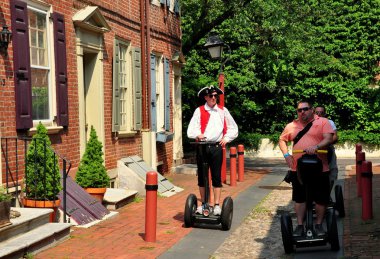 Philadelphia, PA: People Touring Elfreth's Alley on Segues clipart