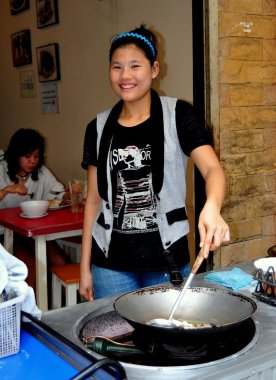 Bangkok, Thailand: Smiling Woman with Wok clipart
