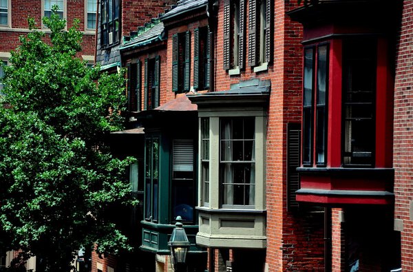 Boston, Massachusetts - July 14, 2013: Bay windows adorn a row of 19th century brick homes on historic Beacon Hill's Mount Vernon Street