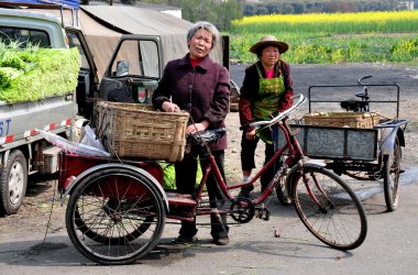 Pengzhou, China: Two Women with Bicycle Carts