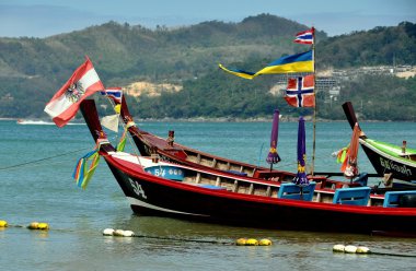 Phuket, Thailand: Thai Longboats Moored at Sea clipart